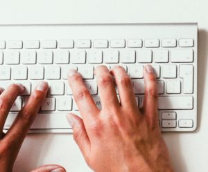 Aptitude hands typing on keyboard